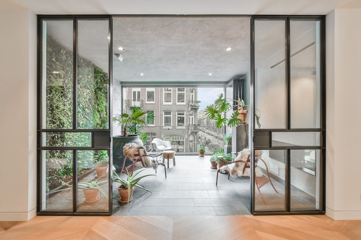 elegant-room-with-balcony-with-various-plants-beautiful-chairs_305343-75