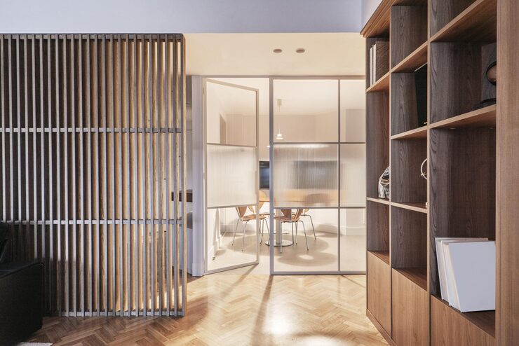 living-room-furnished-with-custommade-oak-wood-bookcase-latticework-same-material-other-side-room_449839-16242