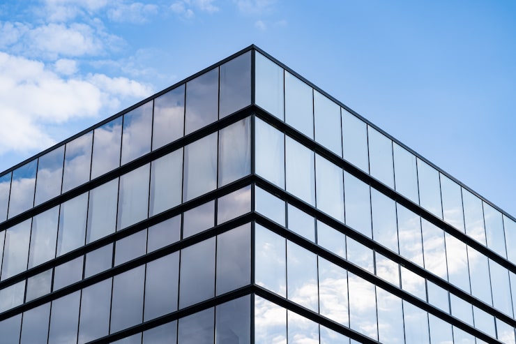 modern-glass-building-architecture-with-blue-sky-clouds_158595-6485